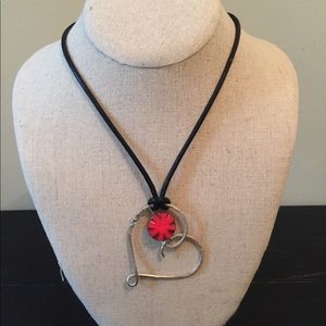 Silver heart shaped pendant in an adjustable cord